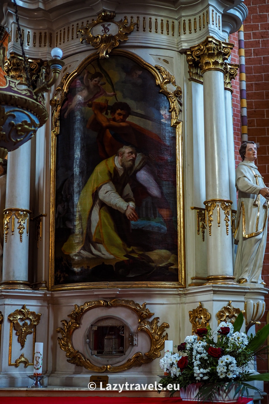Relics of Saint Valentine from the parish church in Chełmno are in a casket under a painting depicting the beheading of the saint.